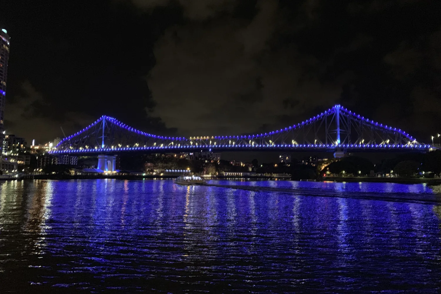 The Story Bridge, a steel cantilever bridge, spanning the Brisbane River at dusk