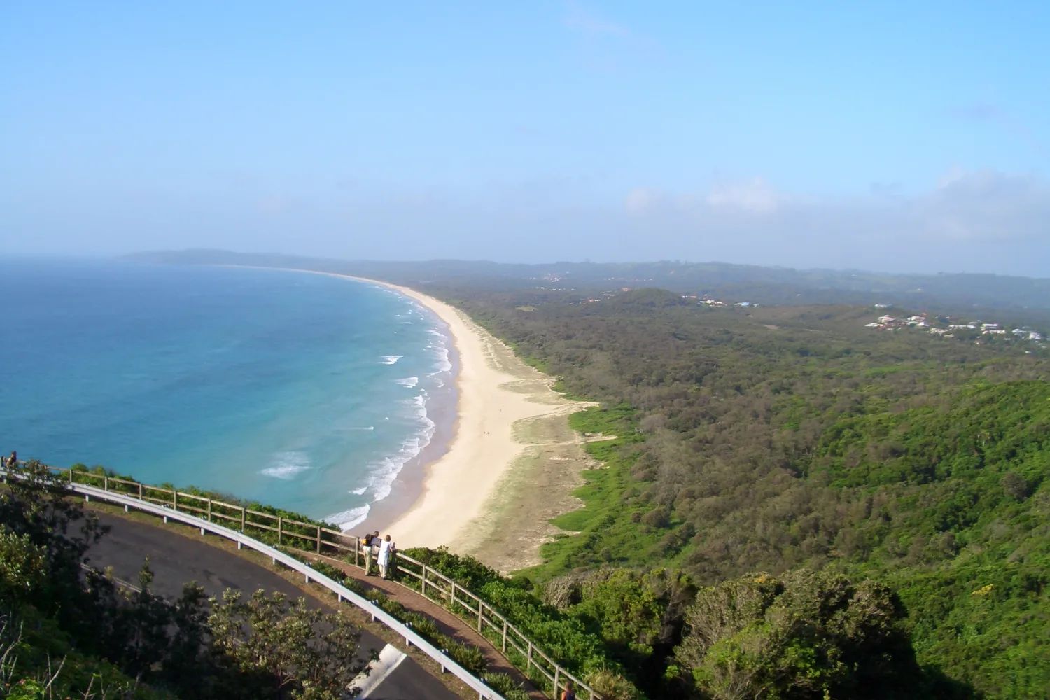Tallow Beach curving away south from Cape Byron, backed by bush, seen from the lighthouse path