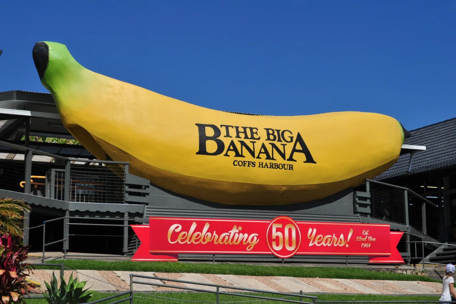 The Big Banana at Coffs Harbour, a giant yellow banana on top of a building, under a blue sky