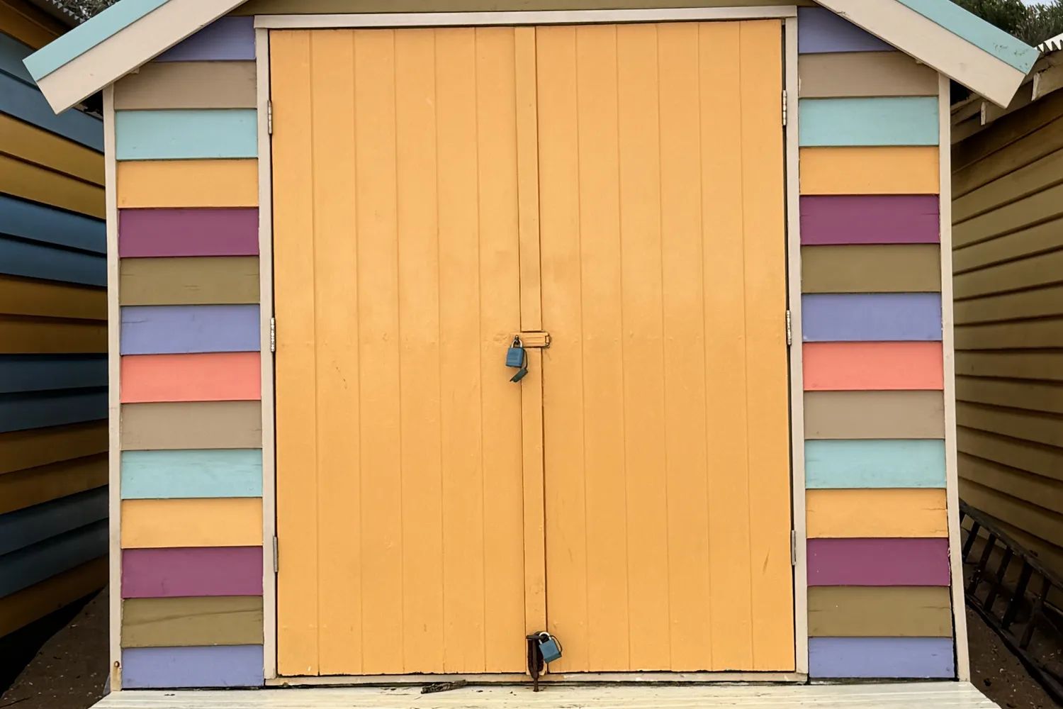 A single bathing box at Brighton, painted in stripes with yellow doors