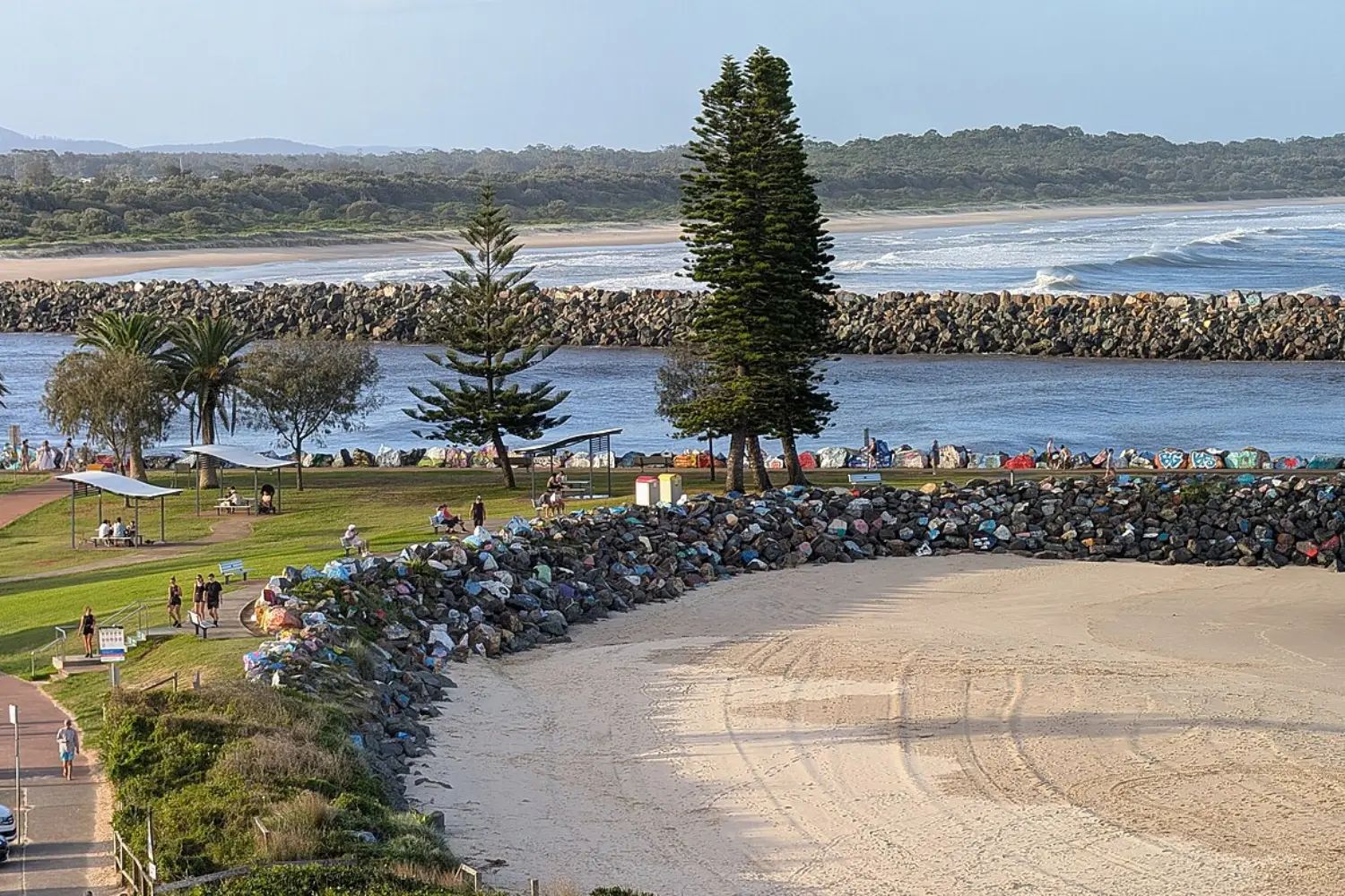 The mouth of the Hastings River at Port Macquarie, with the breakwall running out to sea and the town along the shore