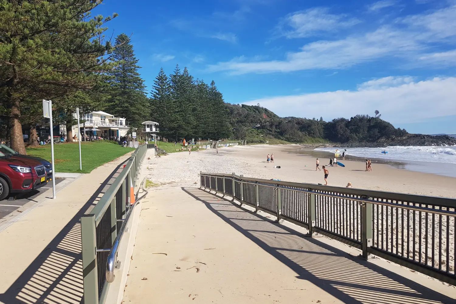 A timber boardwalk path above Flynns Beach at Port Macquarie, with the sea and a sandy cove below