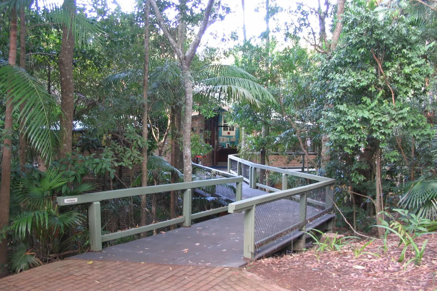 The entrance to the Sea Acres rainforest centre, with a timber boardwalk leading into the trees