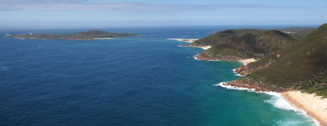 The view from Tomaree Head over the open ocean, with the national-park headlands and beaches running south