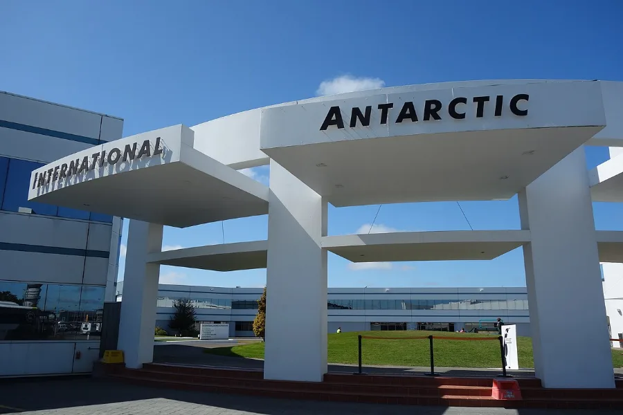 The white entrance canopy of the International Antarctic Centre under a blue sky.