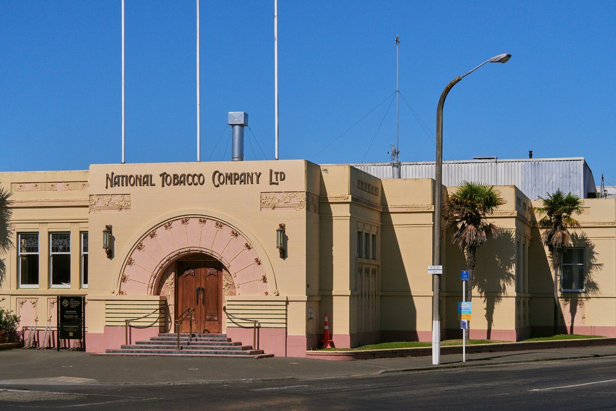 The curved entrance of the National Tobacco Company building in Ahuriri, framed by decorative concrete reliefs