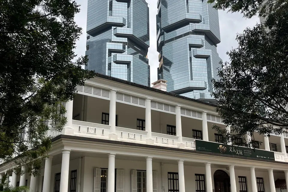 Flagstaff House, white-colonnaded, beneath the Lippo towers