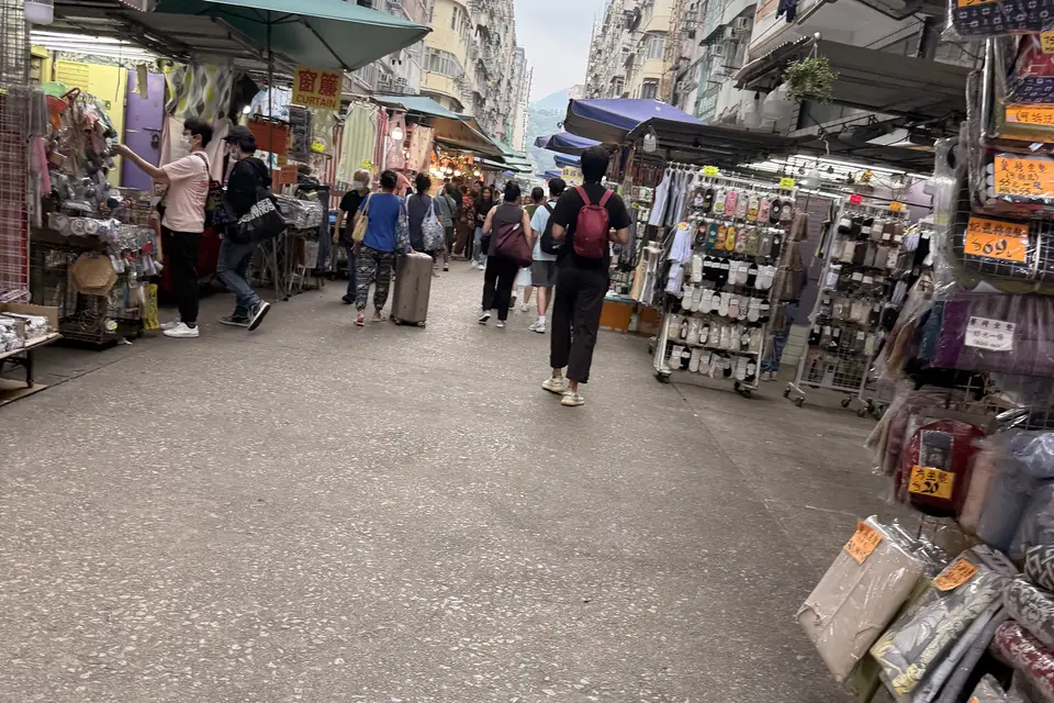 Shoppers walking between market stalls in Mong Kok