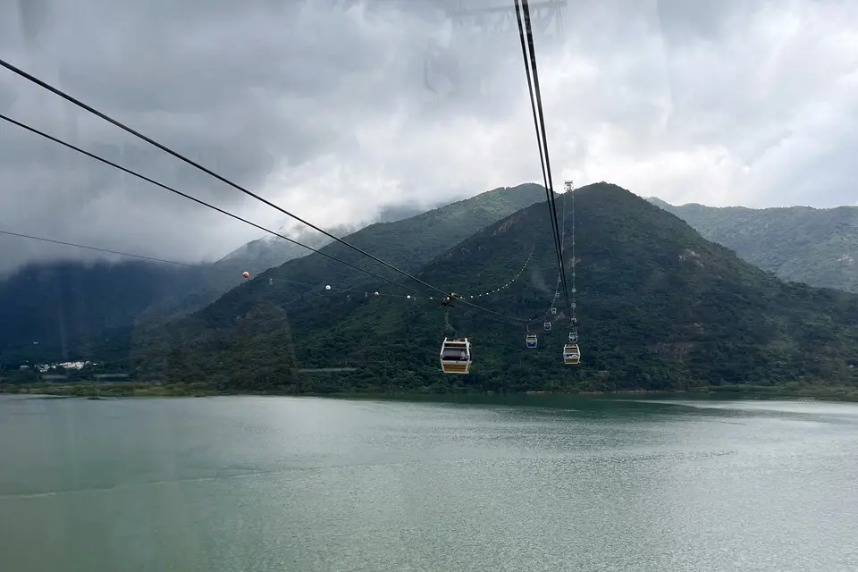 Ngong Ping 360 cabins crossing the bay towards Lantau's hills