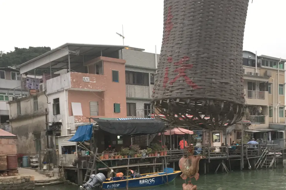 Stilt houses and a giant woven basket above the water at Tai O