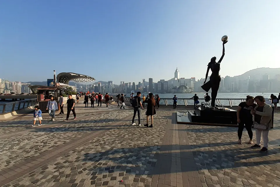 The Avenue of Stars promenade at Tsim Sha Tsui, with a bronze statue and the harbour beyond
