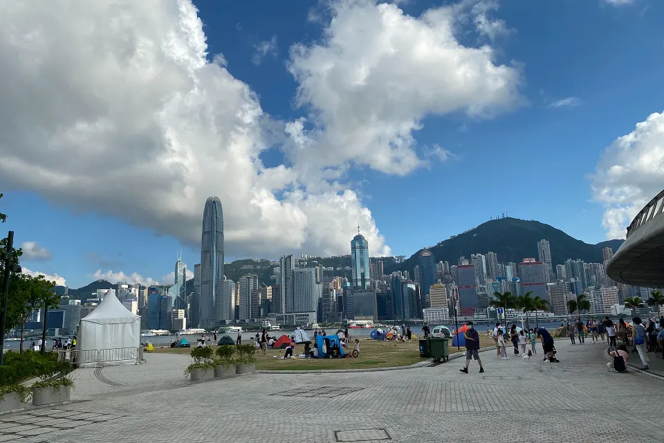 The waterfront promenade at West Kowloon Art Park, with Central and The Peak across the harbour