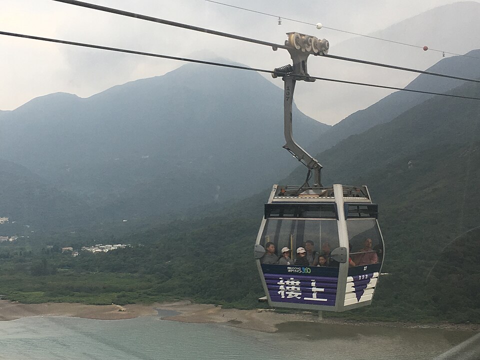 A Ngong Ping 360 cabin crossing towards the hills of Lantau