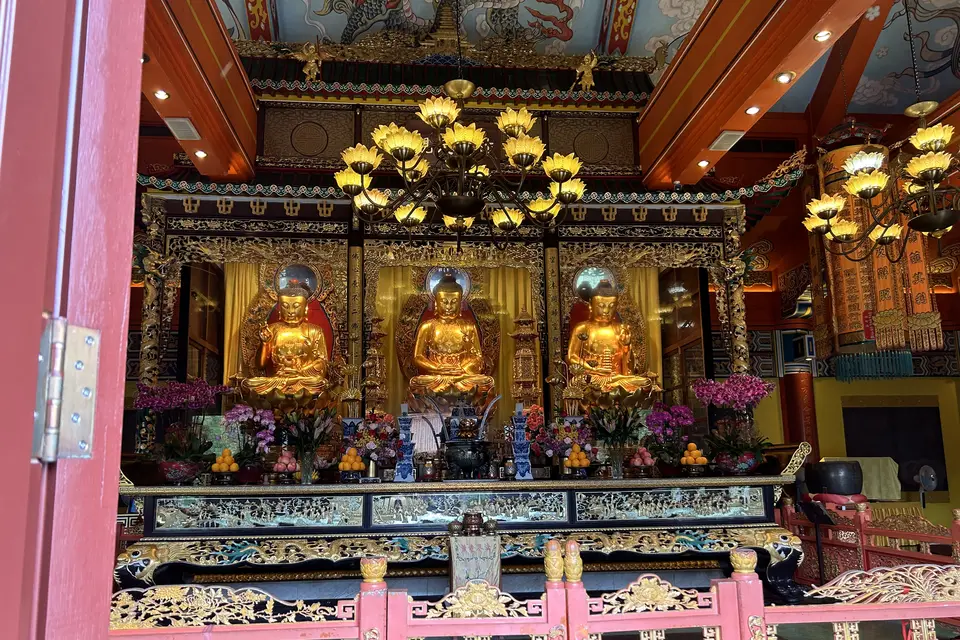 Three gilded Buddhas on the altar inside a hall at Po Lin Monastery