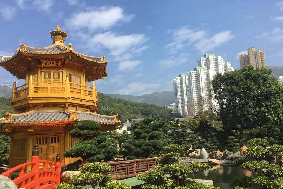 Nan Lian Garden's golden pavilion and red bridge, with the towers of Diamond Hill beyond